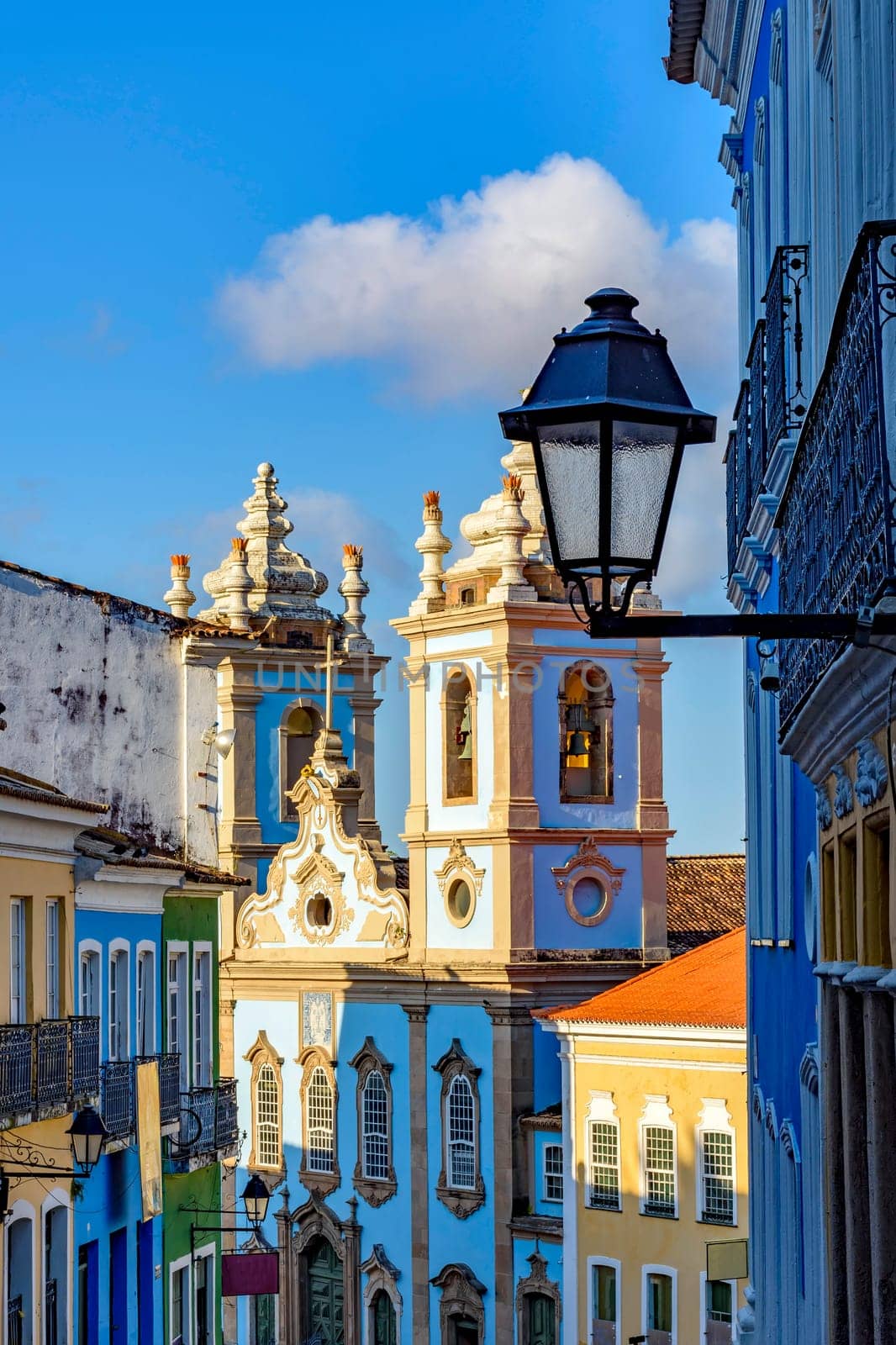 Colorful colonial houses facades and historic church by Fred_Pinheiro