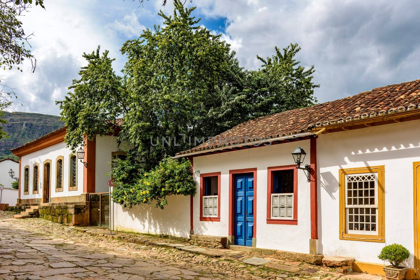View of old colorful colonial houses on a cobbled street by Fred_Pinheiro