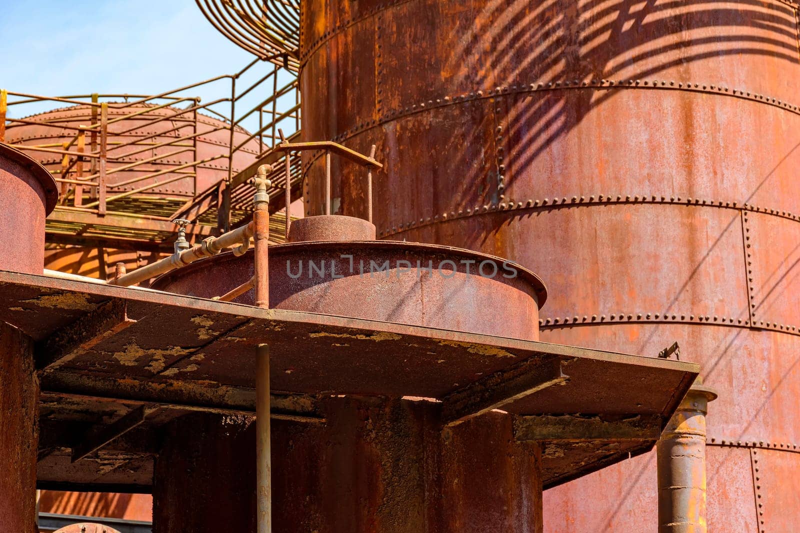 Corroded and rusty gears, tanks and pipes of old machinery for processing abandoned iron ore in Minas Gerais, Brazil