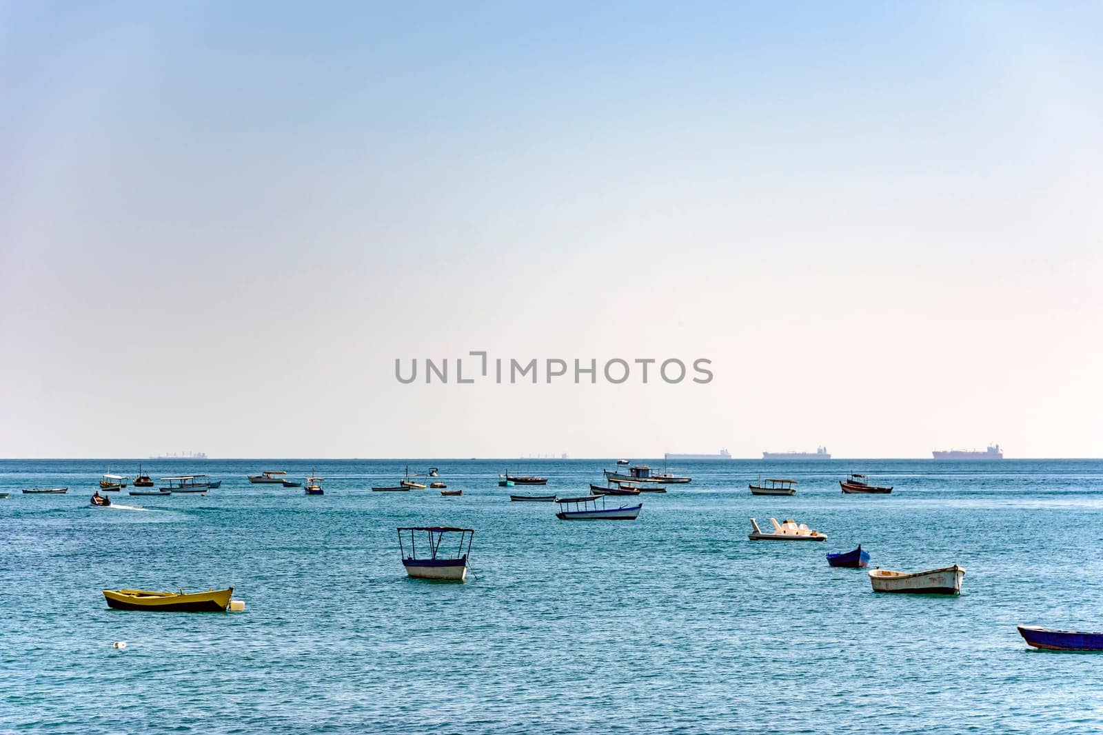 Evening at Todos os Santos bay in Salvador Bahia during a sunny summer day with its moored boats and the skyline