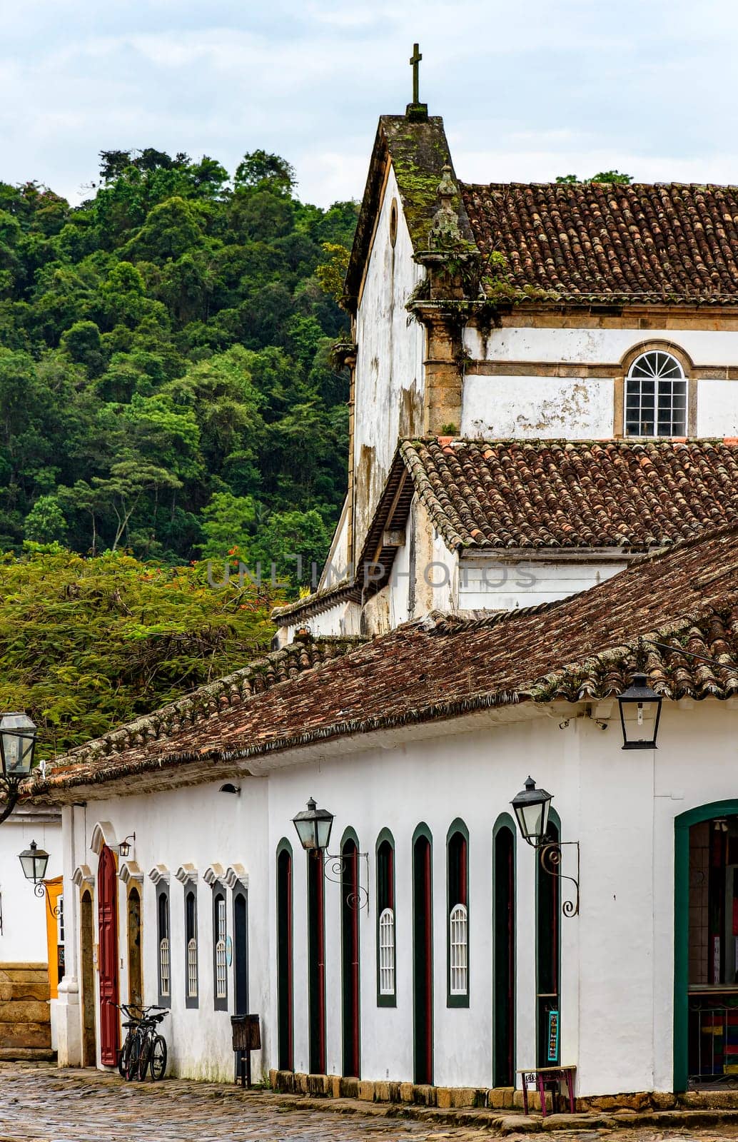 Houses and church with the forest in the background in the historic city of Paraty in Rio de Janeiro, Brazil