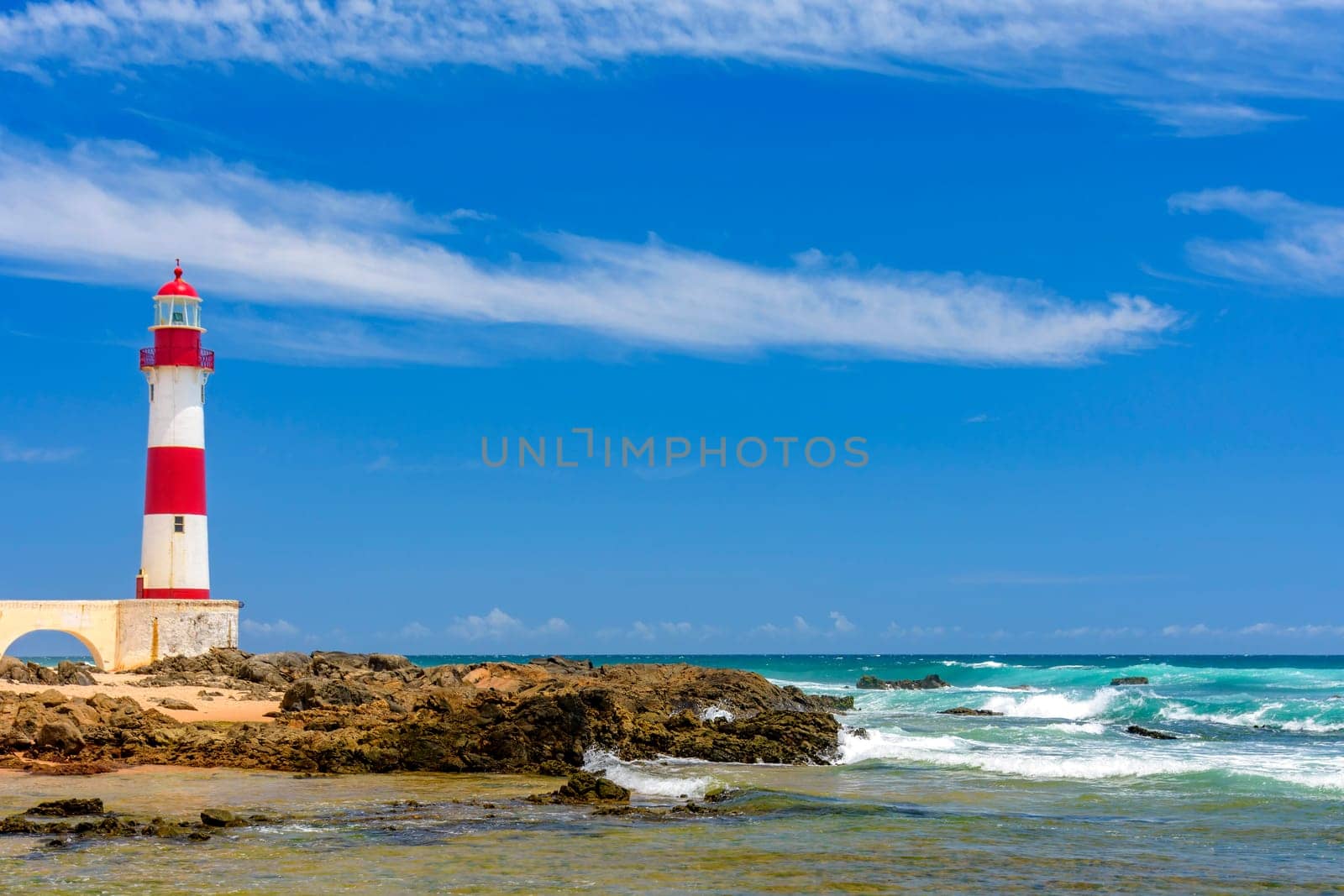 Colorful lighthouse on the sands of Itapua beach by Fred_Pinheiro