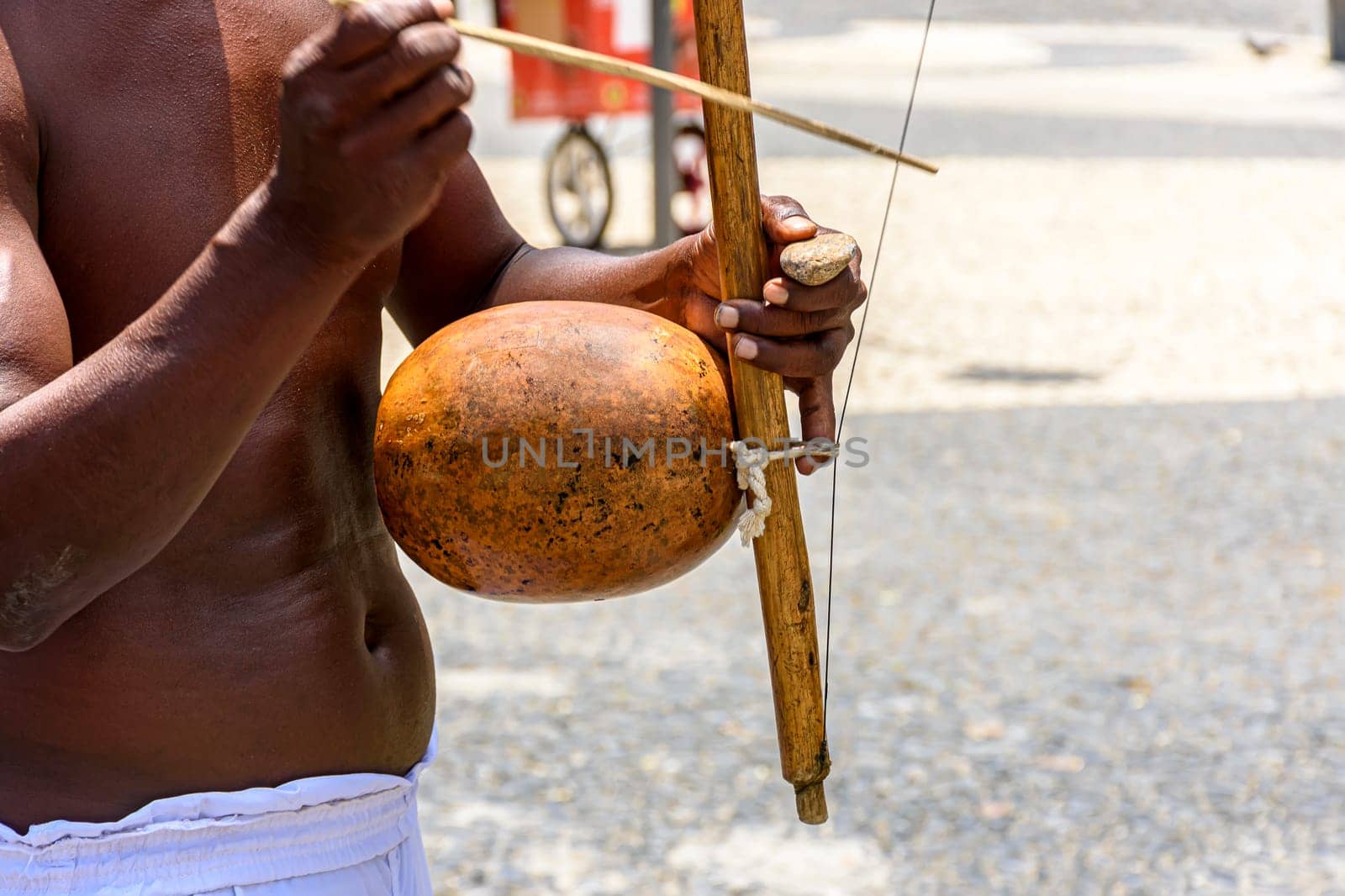 Musicians playing traditional instruments used in capoeira, a mix of fight and dance from Afro-Brazilian culture in the streets of Pelourinho in Salvador, Bahia