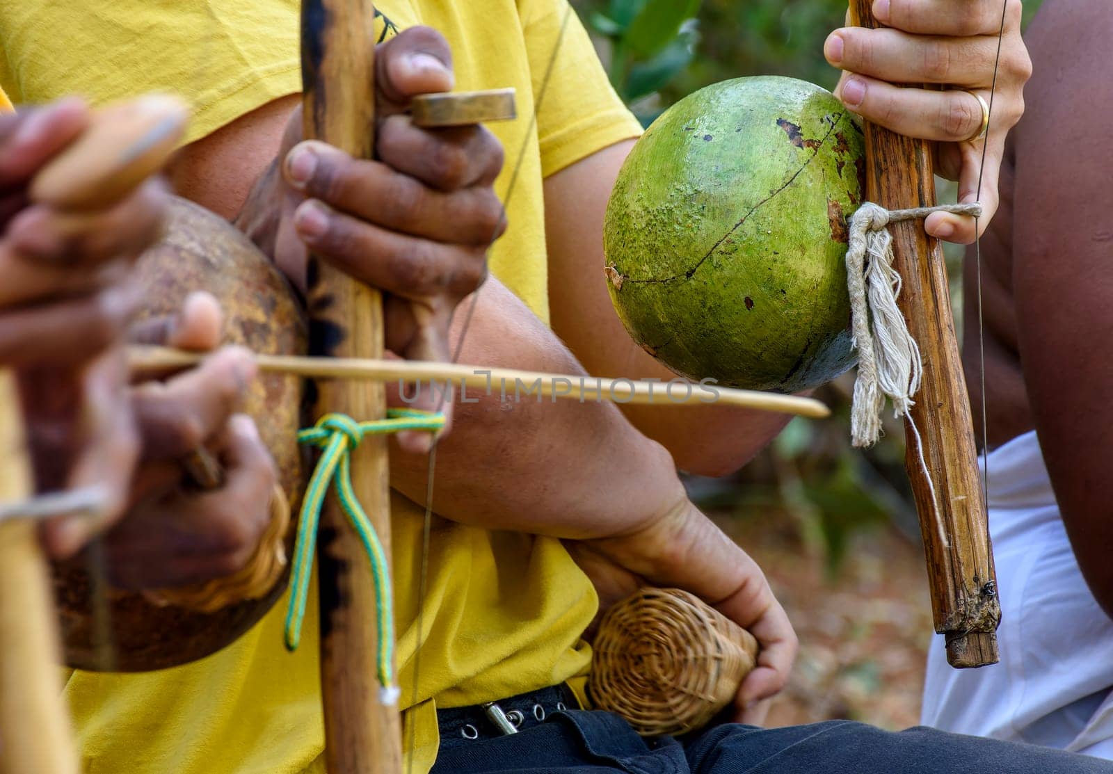 Musicians playing an instrument called berimbau during a capoeira performance in Salvador, Bahia