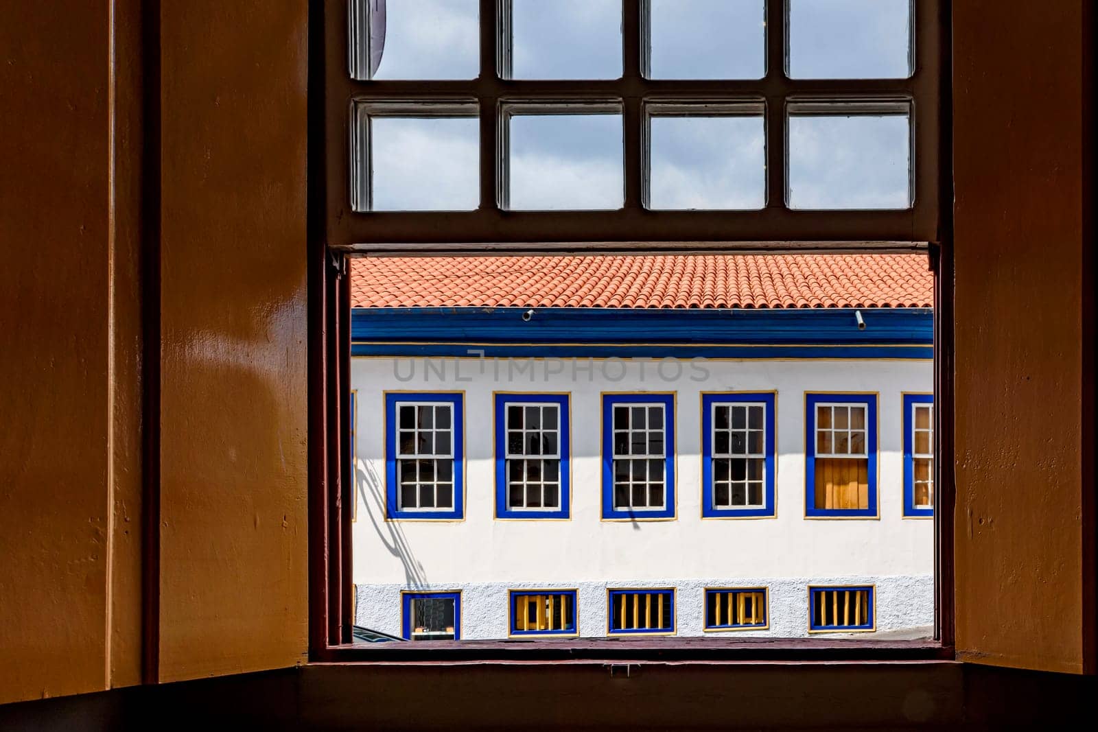 Old colonial style houses seen through a wooden window in the historic town of Diamantina in Minas Gerais, Brazil