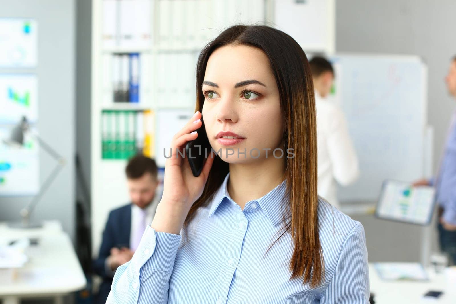 Portrait of beautiful businesswoman with phone in office. Business consultant and stay connected concept