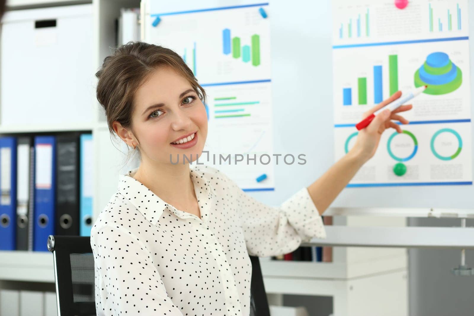 Female mentor conducts training in marketing and analytics in charts by kuprevich