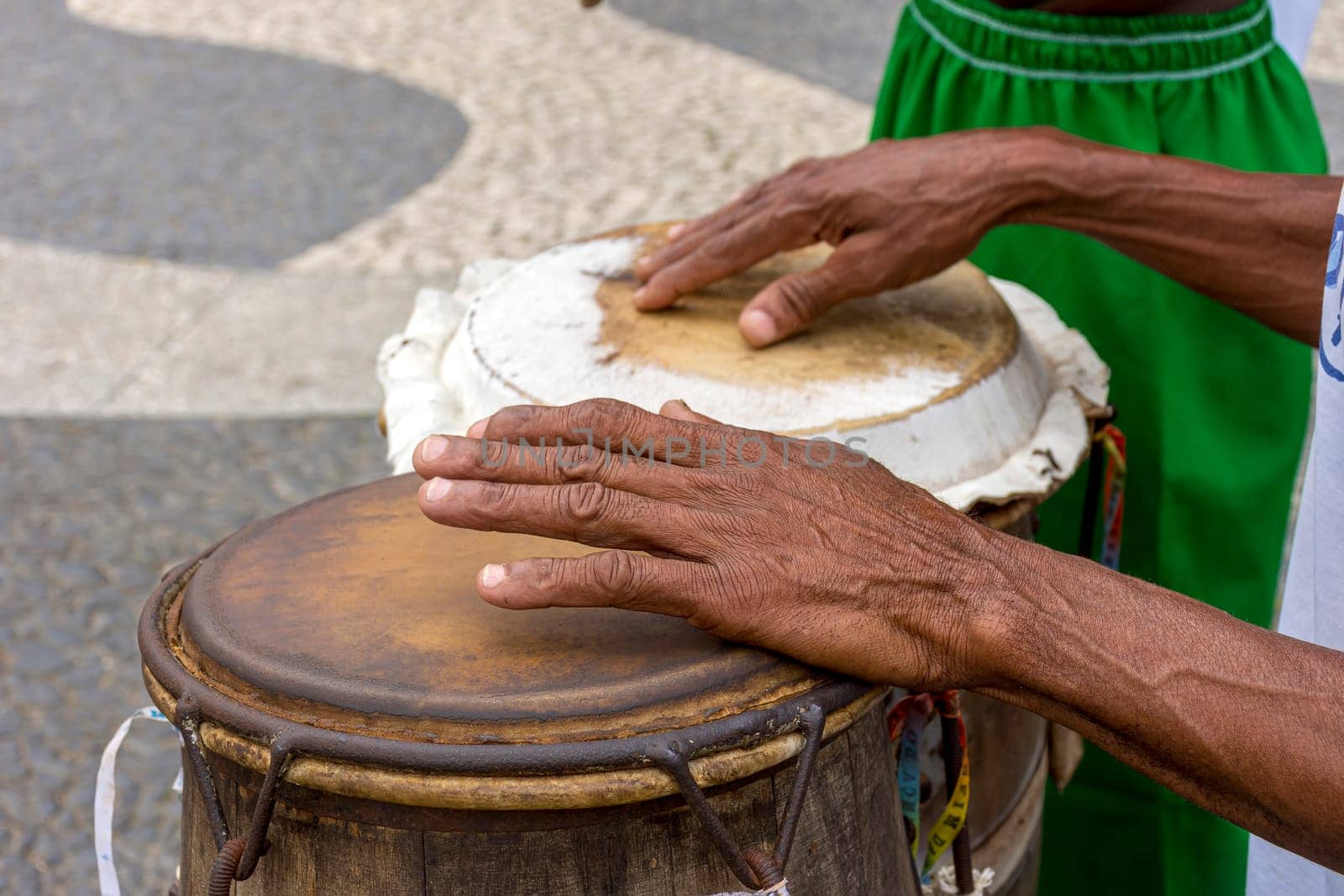 Percussionist playing a rudimentary atabaque during afro-brazilian cultural manifestation at Pelourinho on Salvador city, Bahia