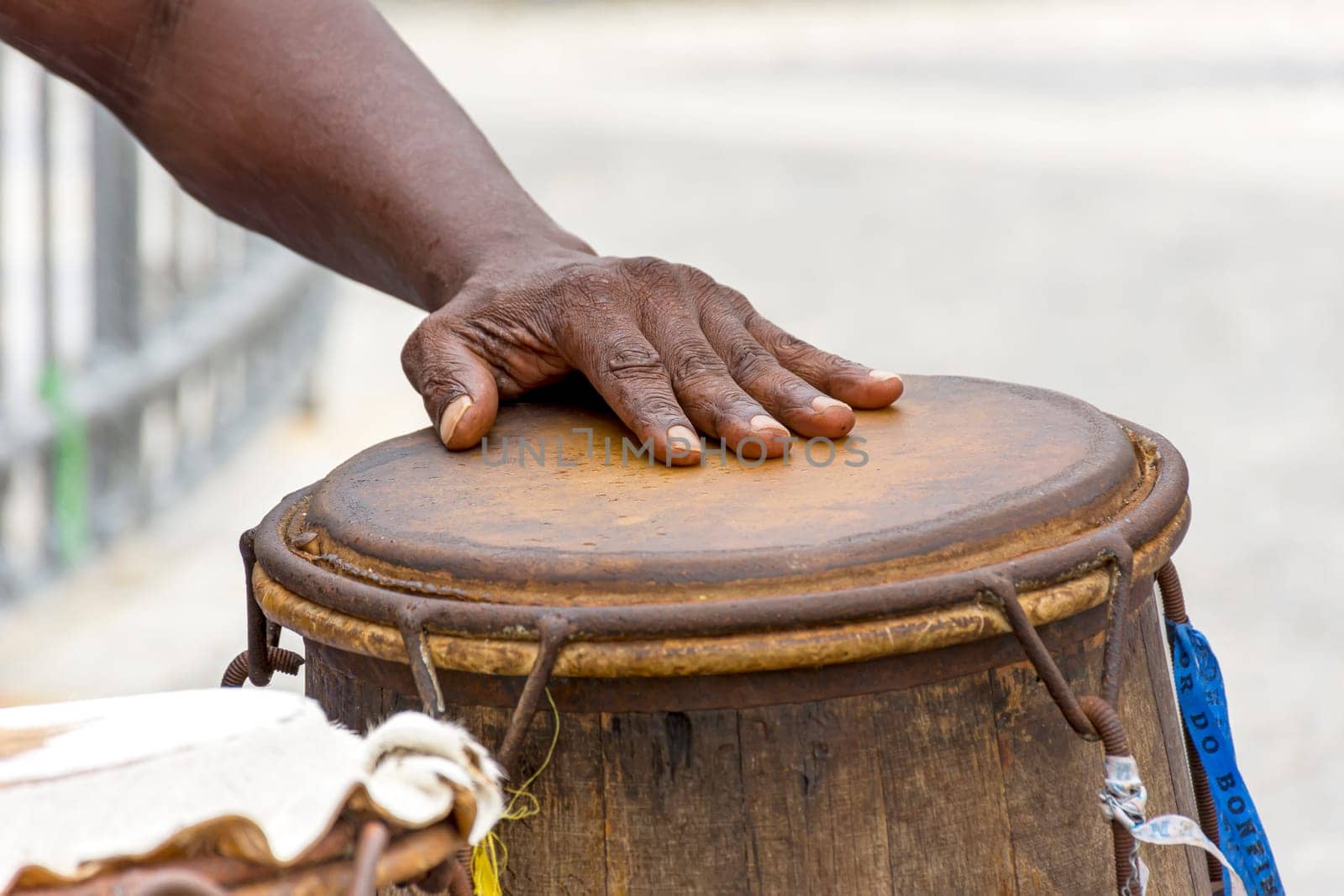 Percussionist playing a rudimentary atabaque during afro-brazilian capoeira fight at Pelourinho on Salvador city, Bahia