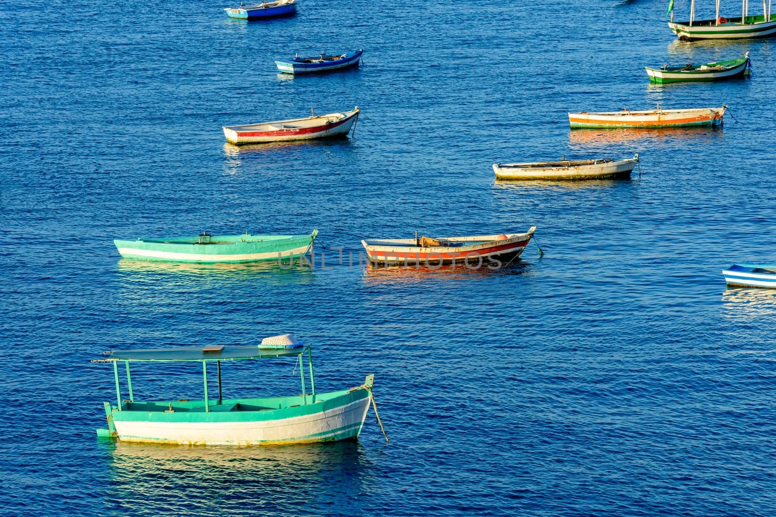 Rustic wooden fishing boats in the sea of the city of Salvador in Bahia