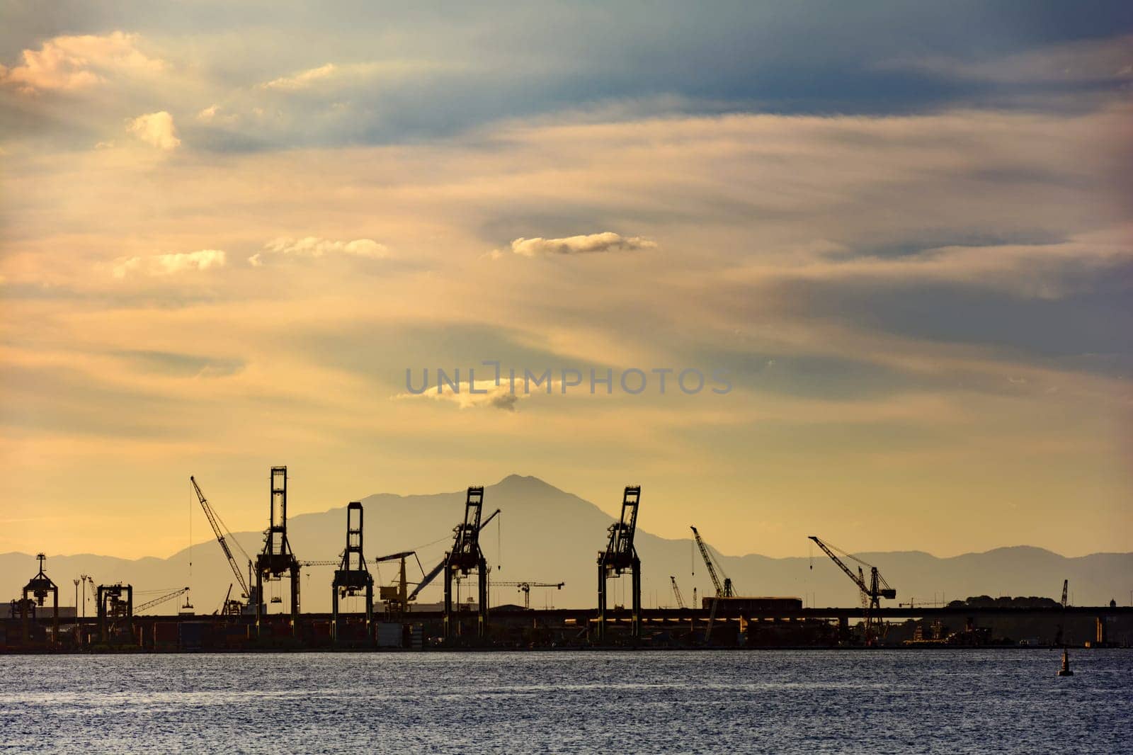 Silhouette of the harbor pier with its cranes seen during sunset on Rio de Janeiro, Brazil