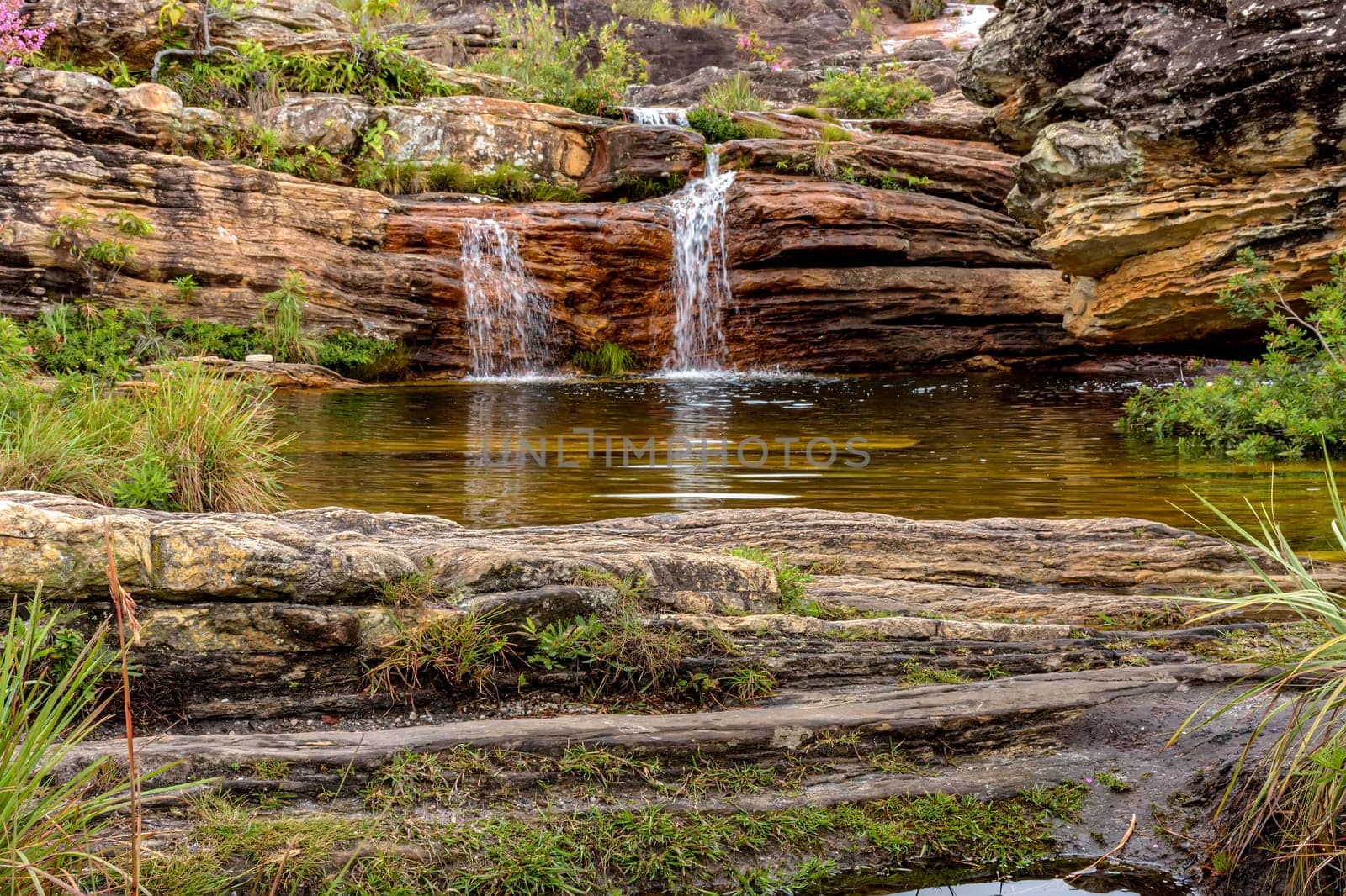Stream and waterfall among the preserved vegetation of the Biribiri environmental reserve in Diamantina, Minas Gerais, Brazil