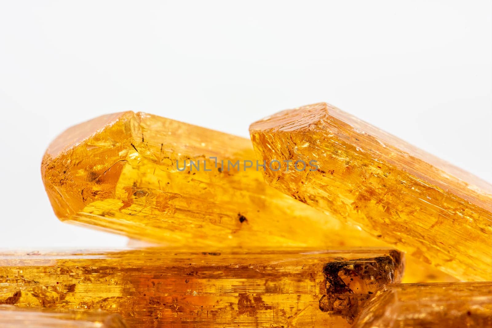 Studio photography of some Brazilian imperial topaz in raw state with white background