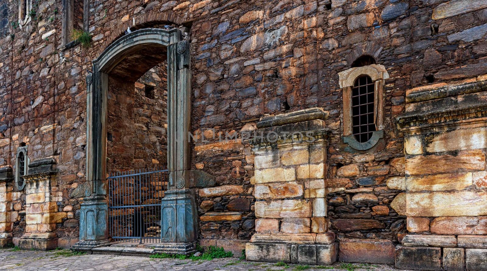 Strong stone walls of unfinished historic colonial church in ruins in the city of Sabara in Minas Gerais, Brazil