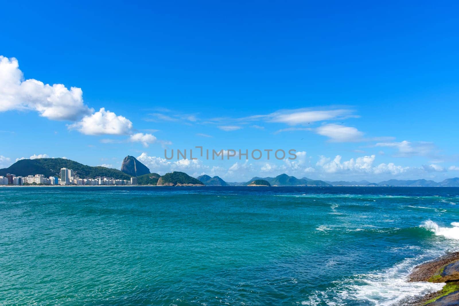 Sunny day at Copacabana beach on Rio de Janeiro citybeach with the sugar loaf hill on backgroud