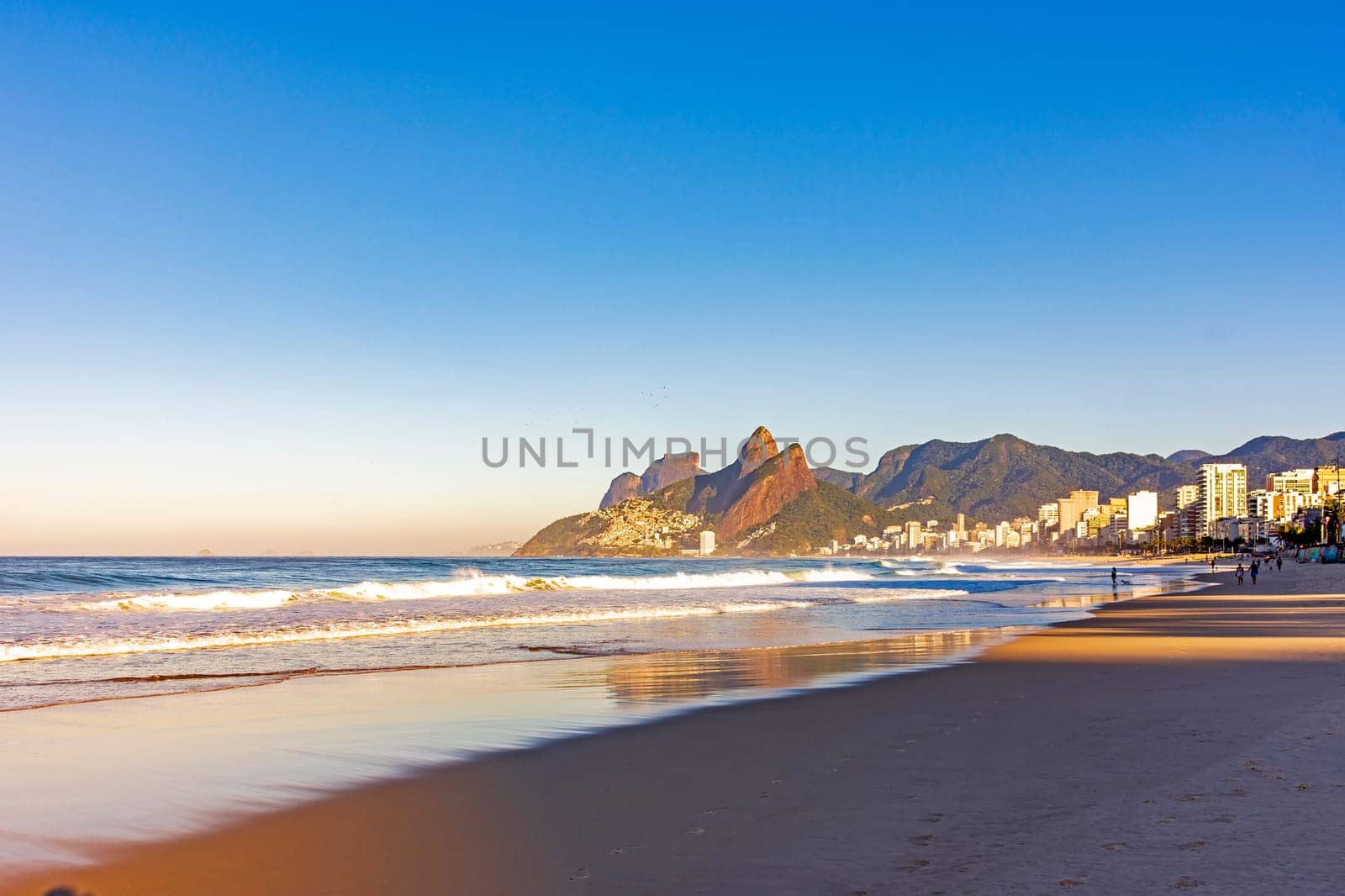 Sunrise on Ipanema beach in Rio de Janeiro with the sea and mountains