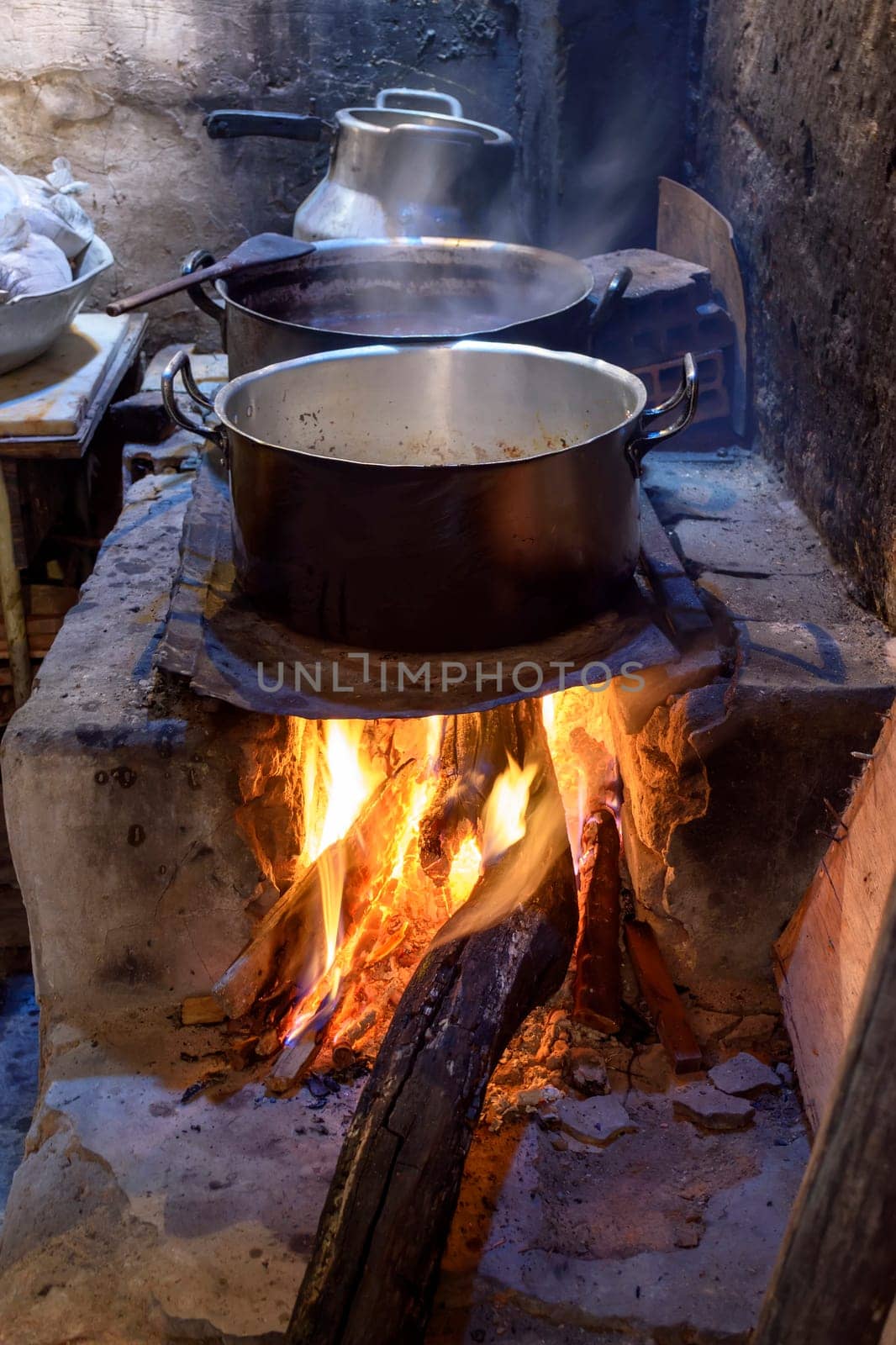Traditional Brazilian food being prepared on old, dirty and popular wood stove