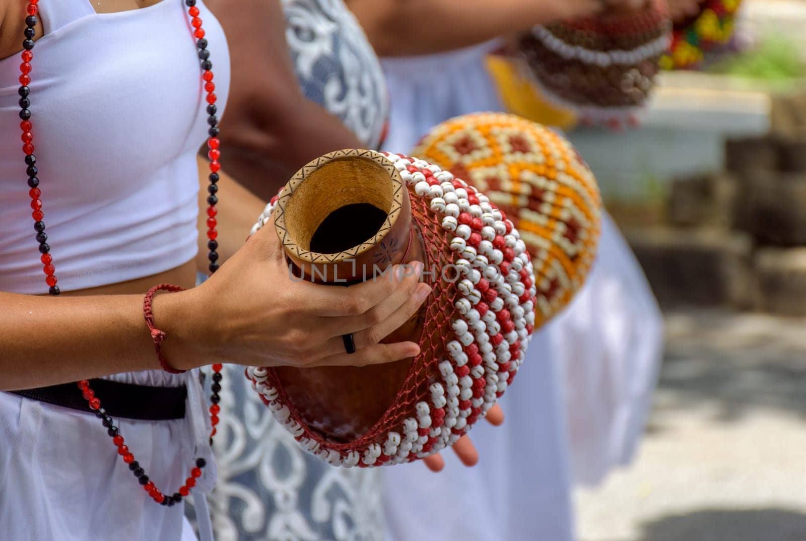 Woman playing a type of rattle called xereque of African origin by Fred_Pinheiro