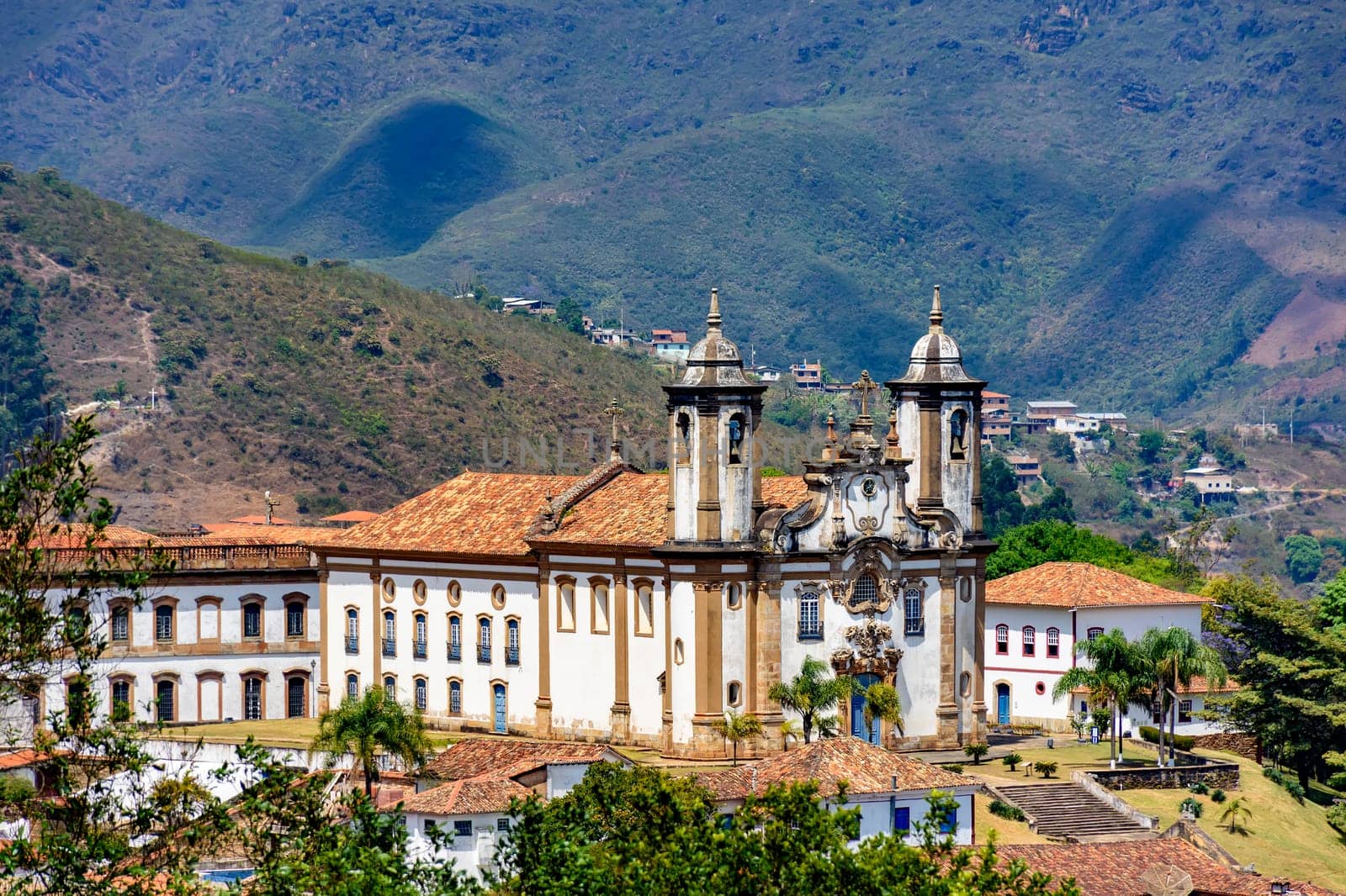 View of historic 18th century church in colonial architecture in the city of Ouro Preto in Minas Gerais, Brazil with hills in background