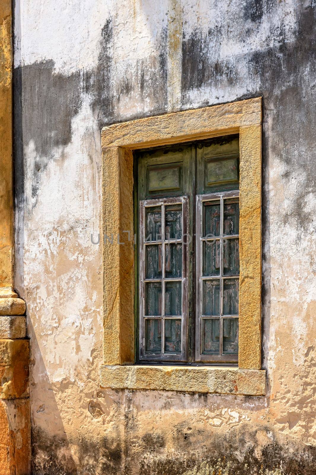 Window on the side of an old church in colonial architecture by Fred_Pinheiro