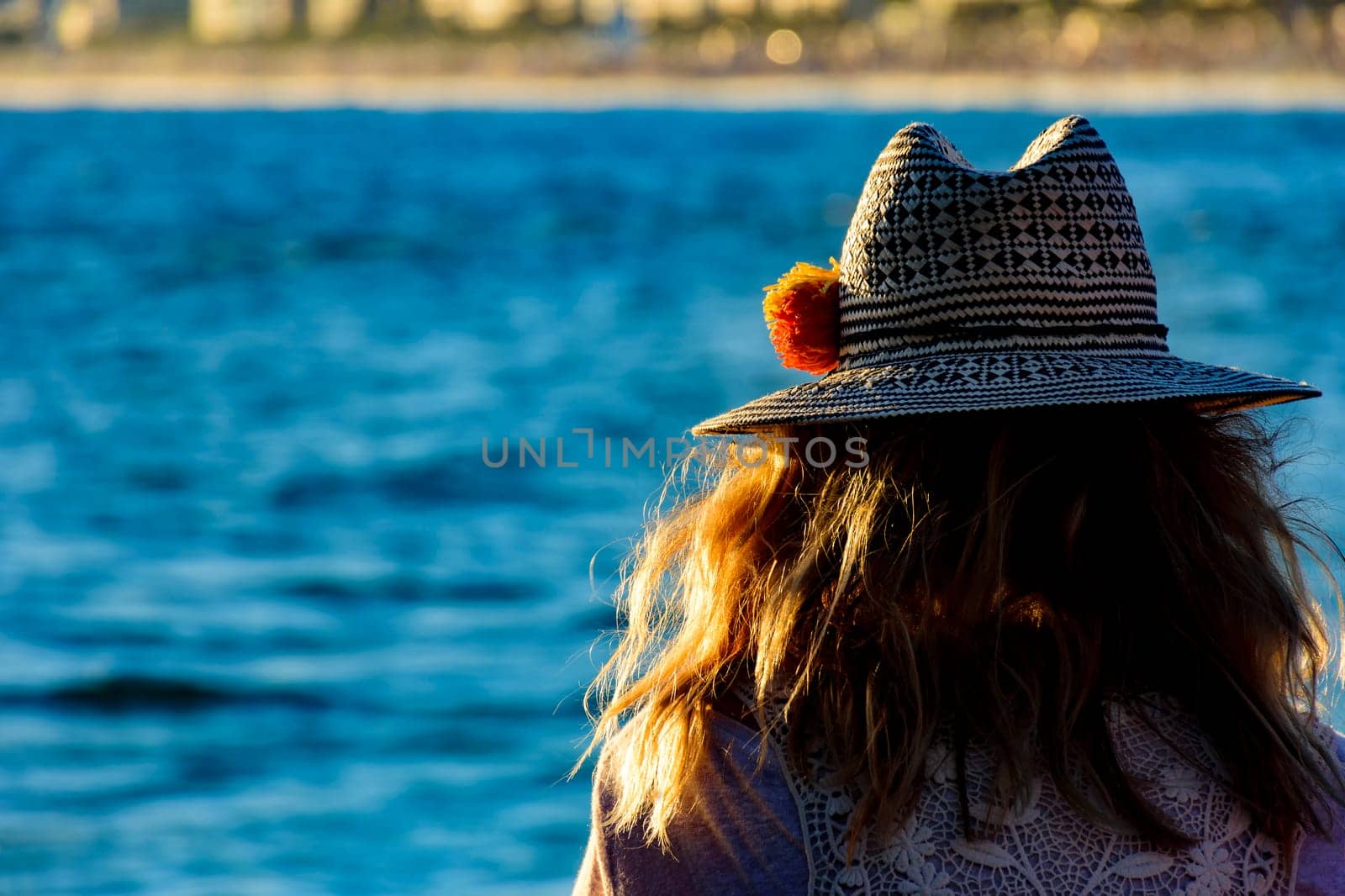 Woman with flower hat looking at Ipanema beach by Fred_Pinheiro