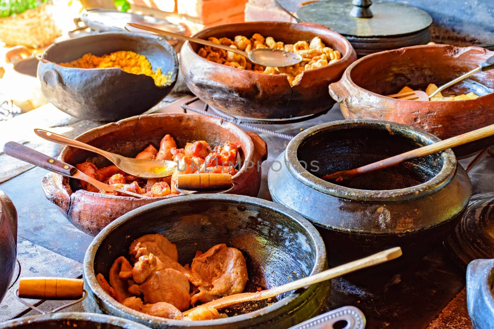 Traditional Brazilian food being prepared in clay pots by Fred_Pinheiro