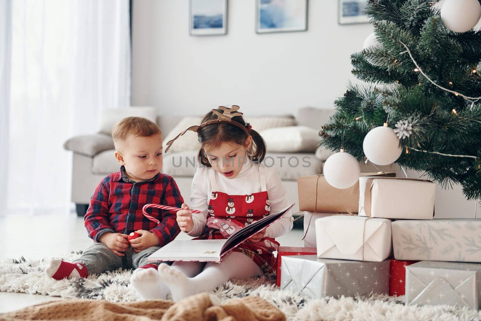 Little brother with her daughter celebrates New year and christmas at home.