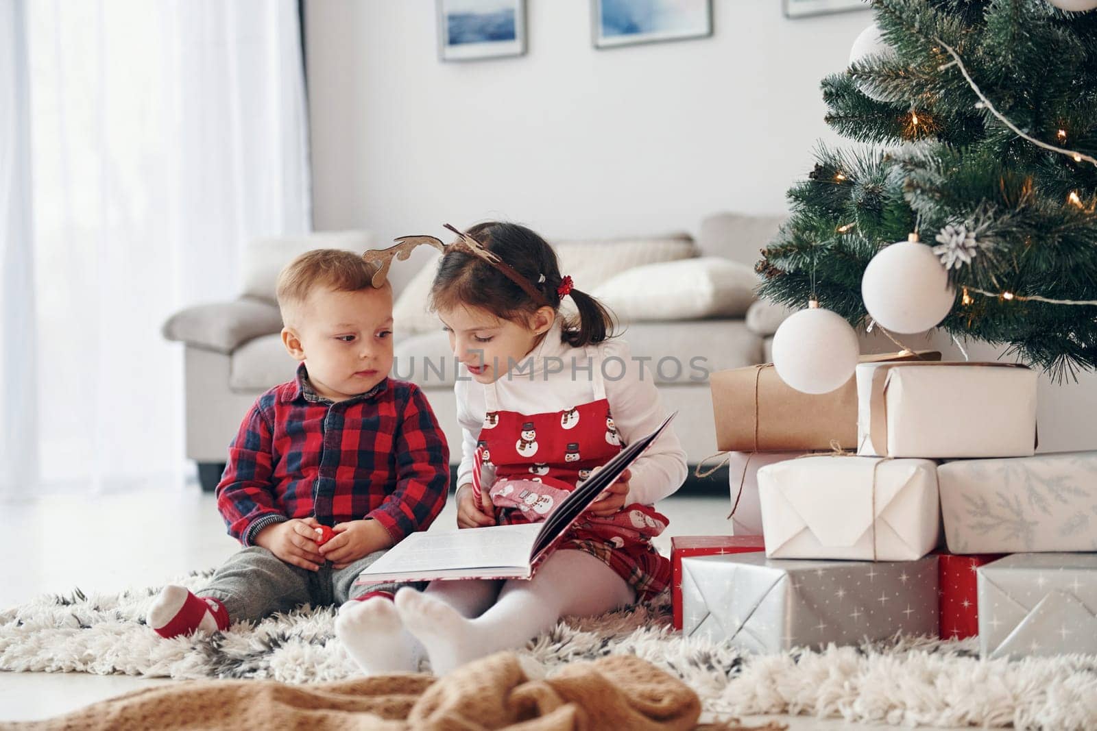 Little brother with her daughter celebrates New year and christmas at home.