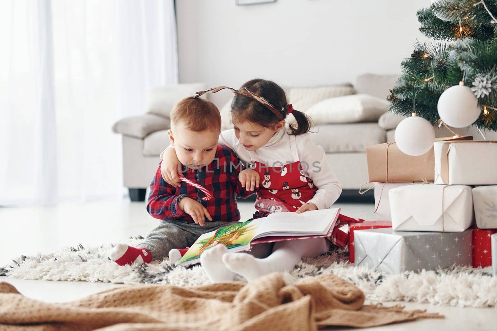 Little brother with her daughter celebrates New year and christmas at home.
