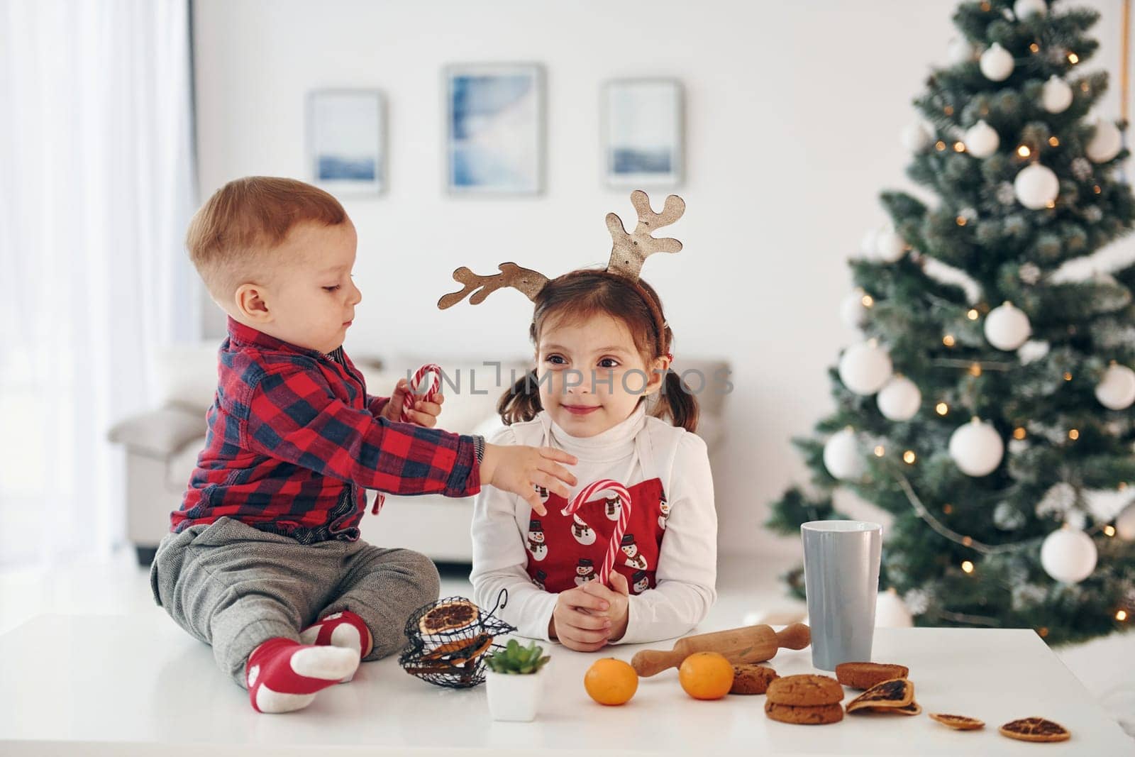 Little brother with her daughter celebrates New year and christmas at home.