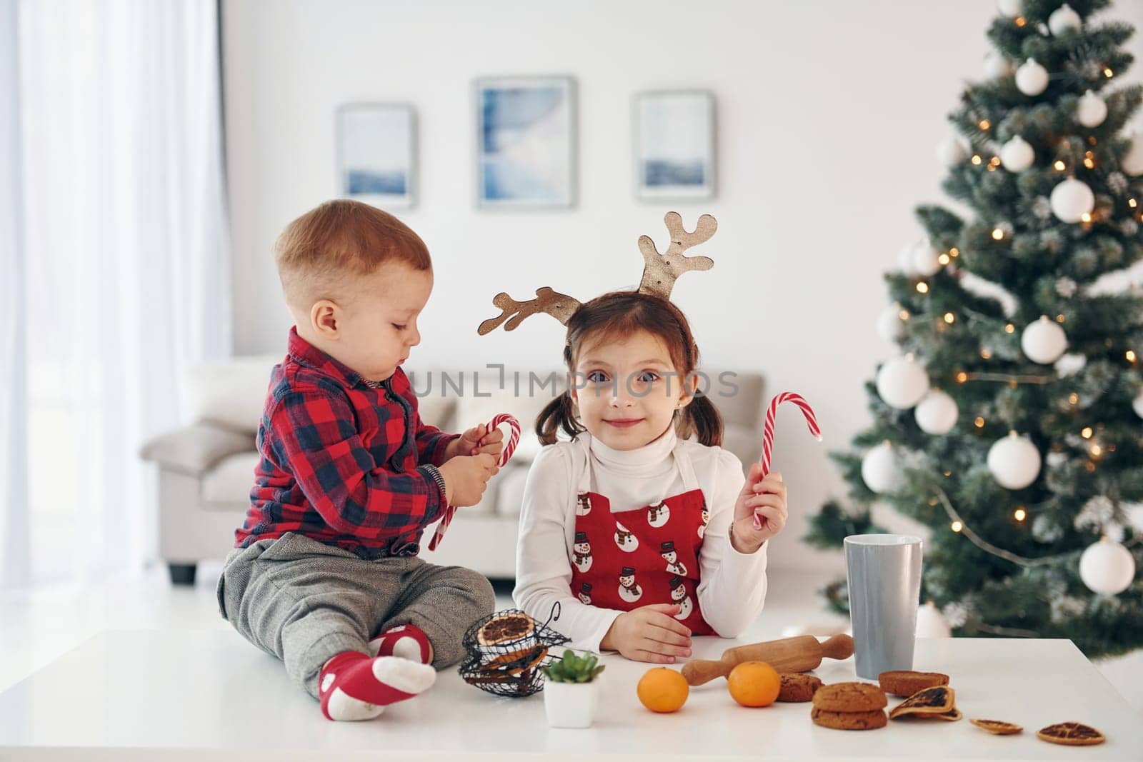 Little brother with her daughter celebrates New year and christmas at home.
