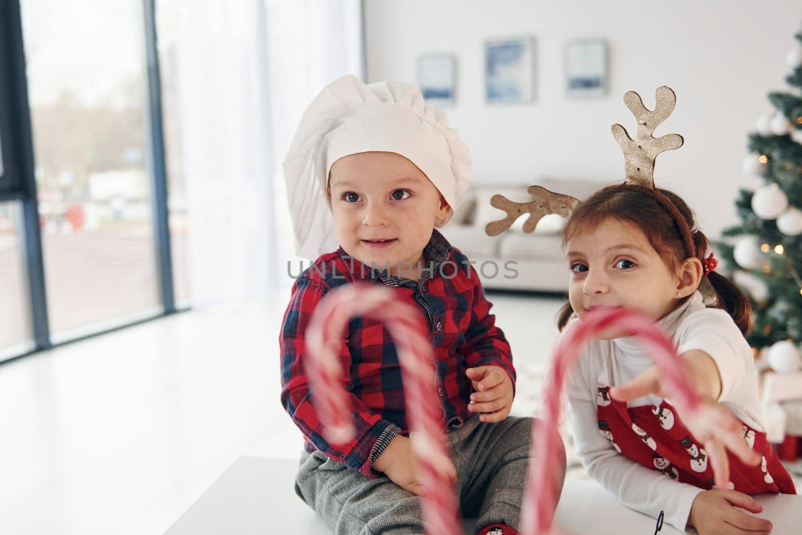 Little brother with her daughter celebrates New year and christmas at home.