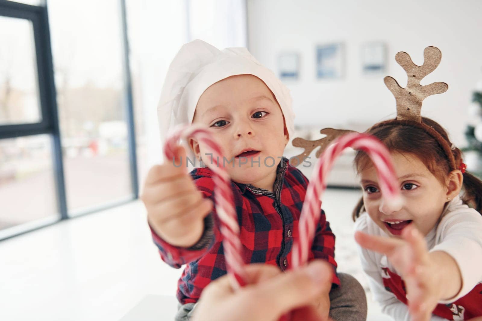 Little brother with her daughter celebrates New year and christmas at home.