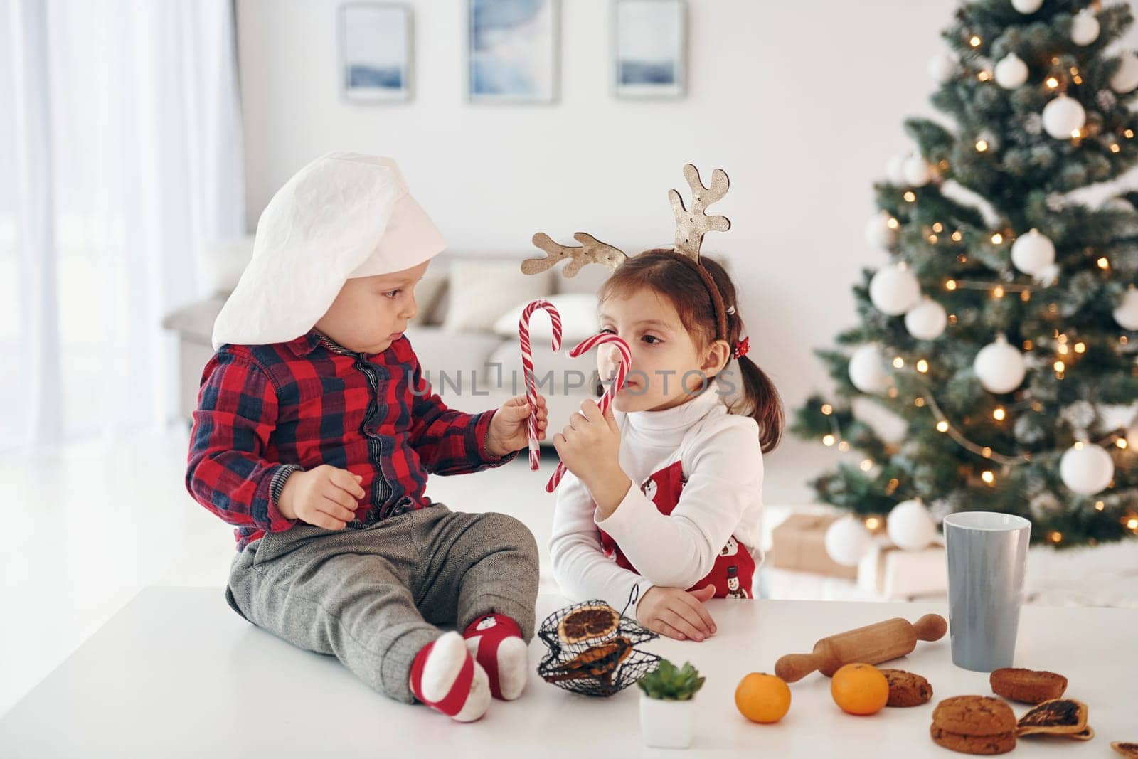 Little brother with her daughter celebrates New year and christmas at home.