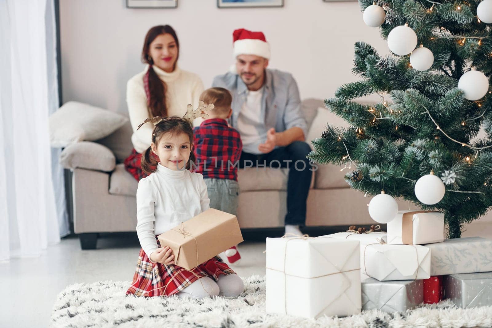 Beautiful family celebrates New year and christmas indoors at home.