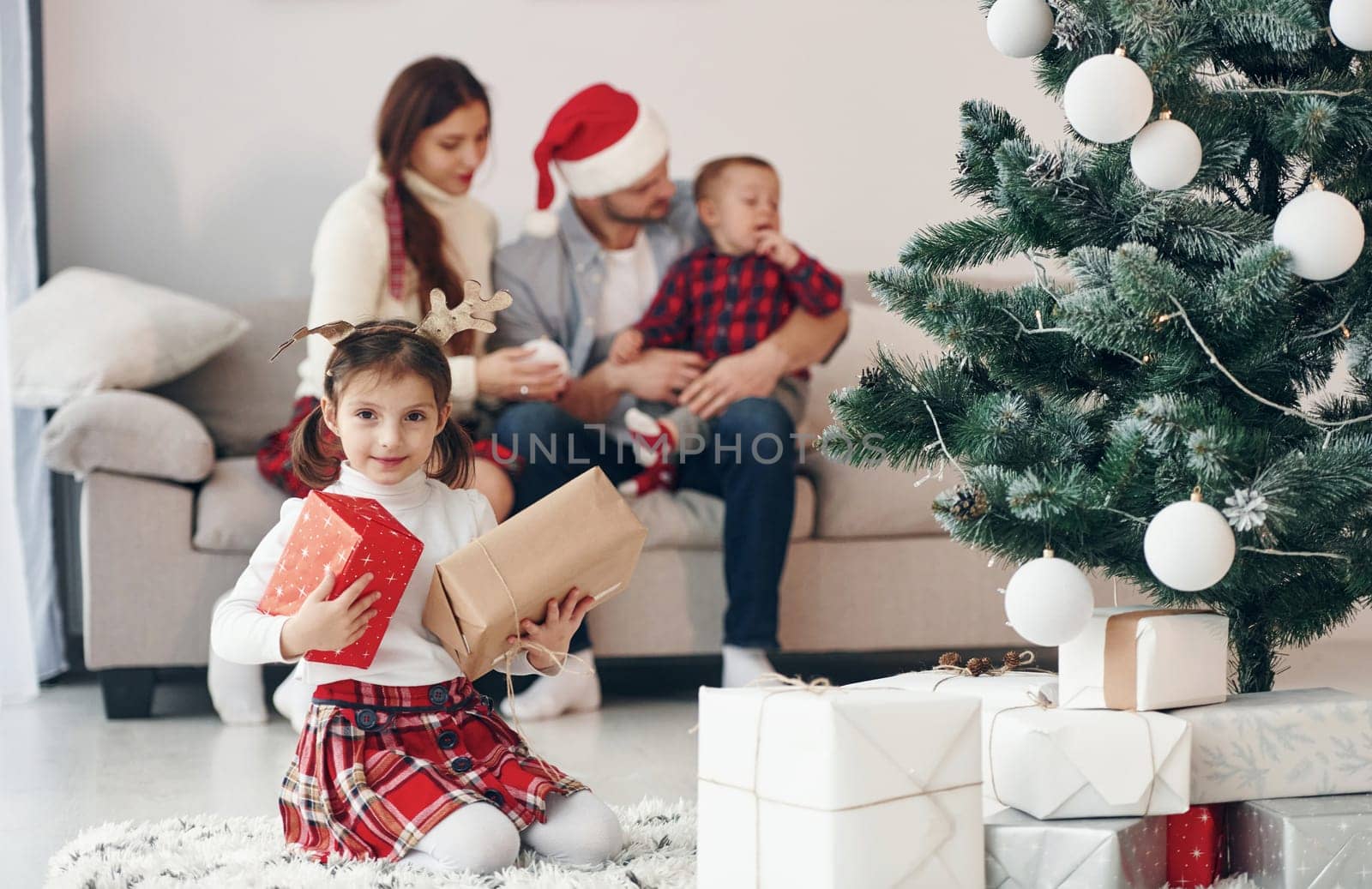 Beautiful family celebrates New year and christmas indoors at home.