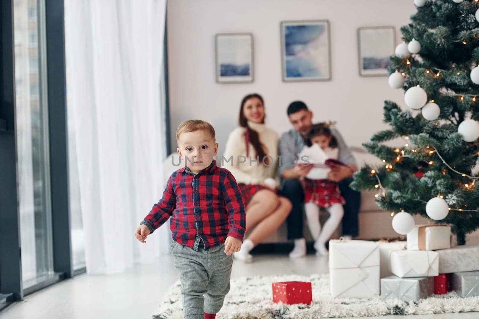 Beautiful family celebrates New year and christmas indoors at home.