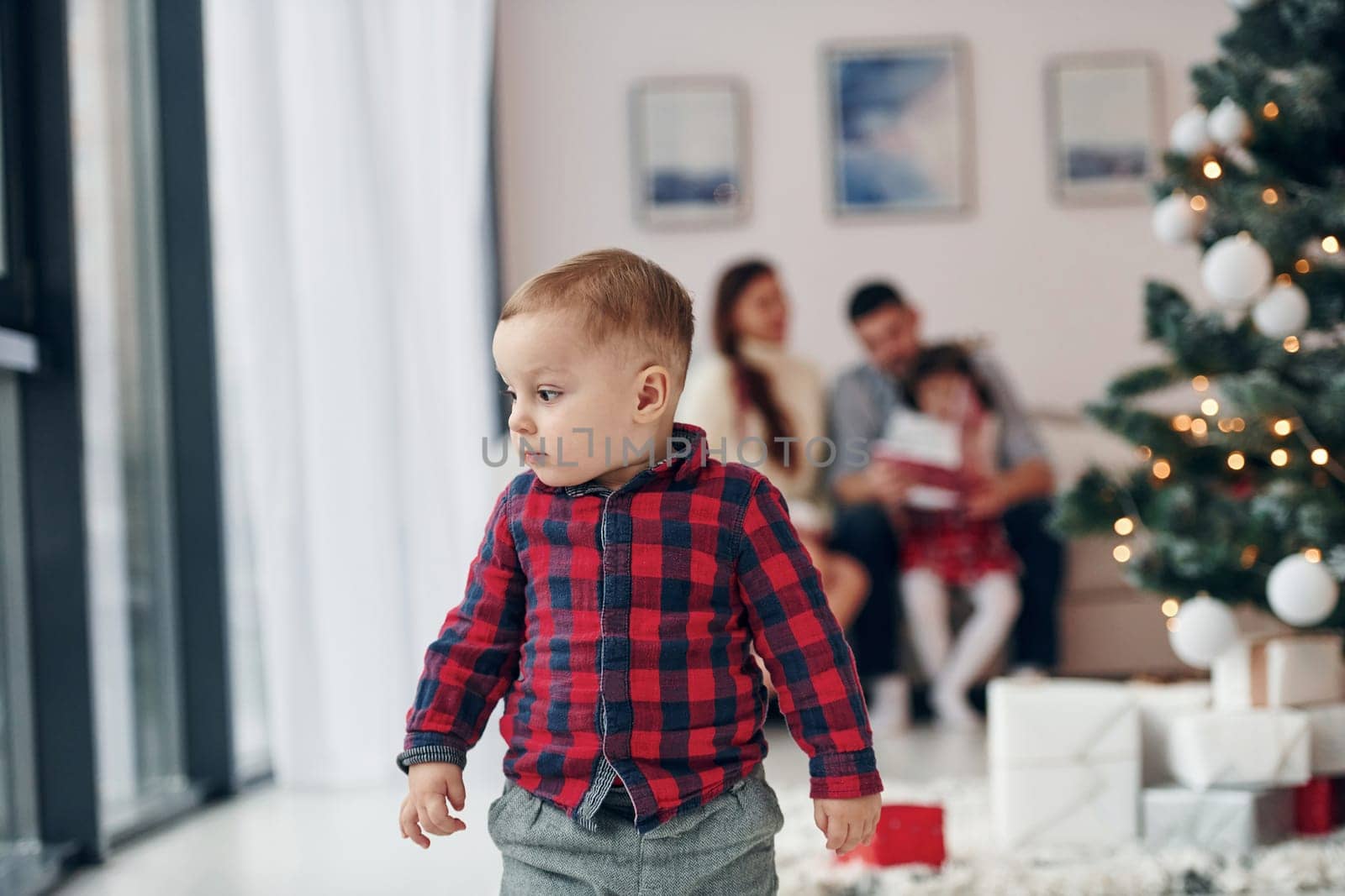 Beautiful family celebrates New year and christmas indoors at home.