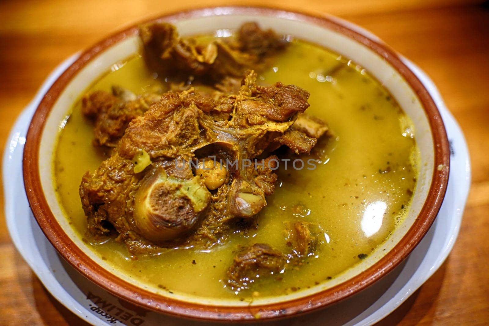 Tengkleng Kambing. Traditional Indonesian spicy soup made from the bones of goat served in a bowl.
