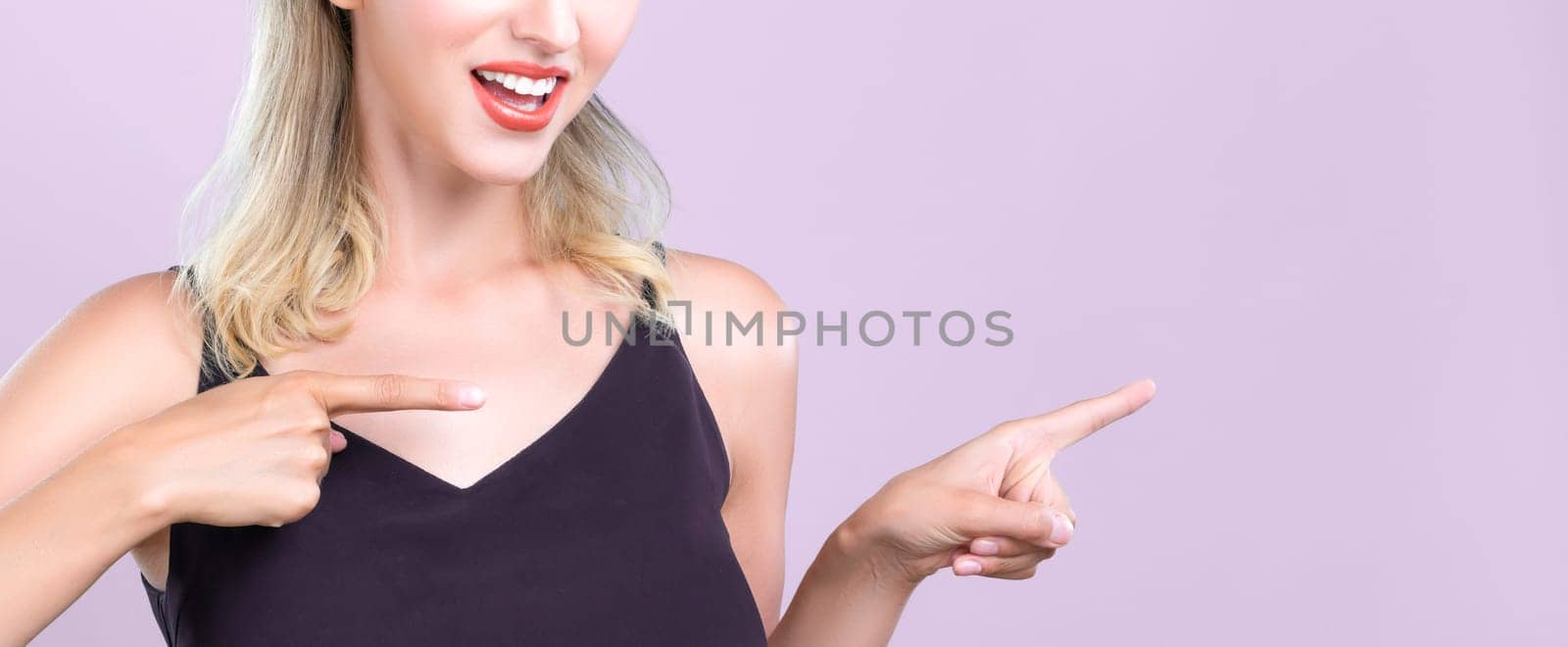 Closeup alluring woman portrait pointing finger side way in isolated background. by biancoblue
