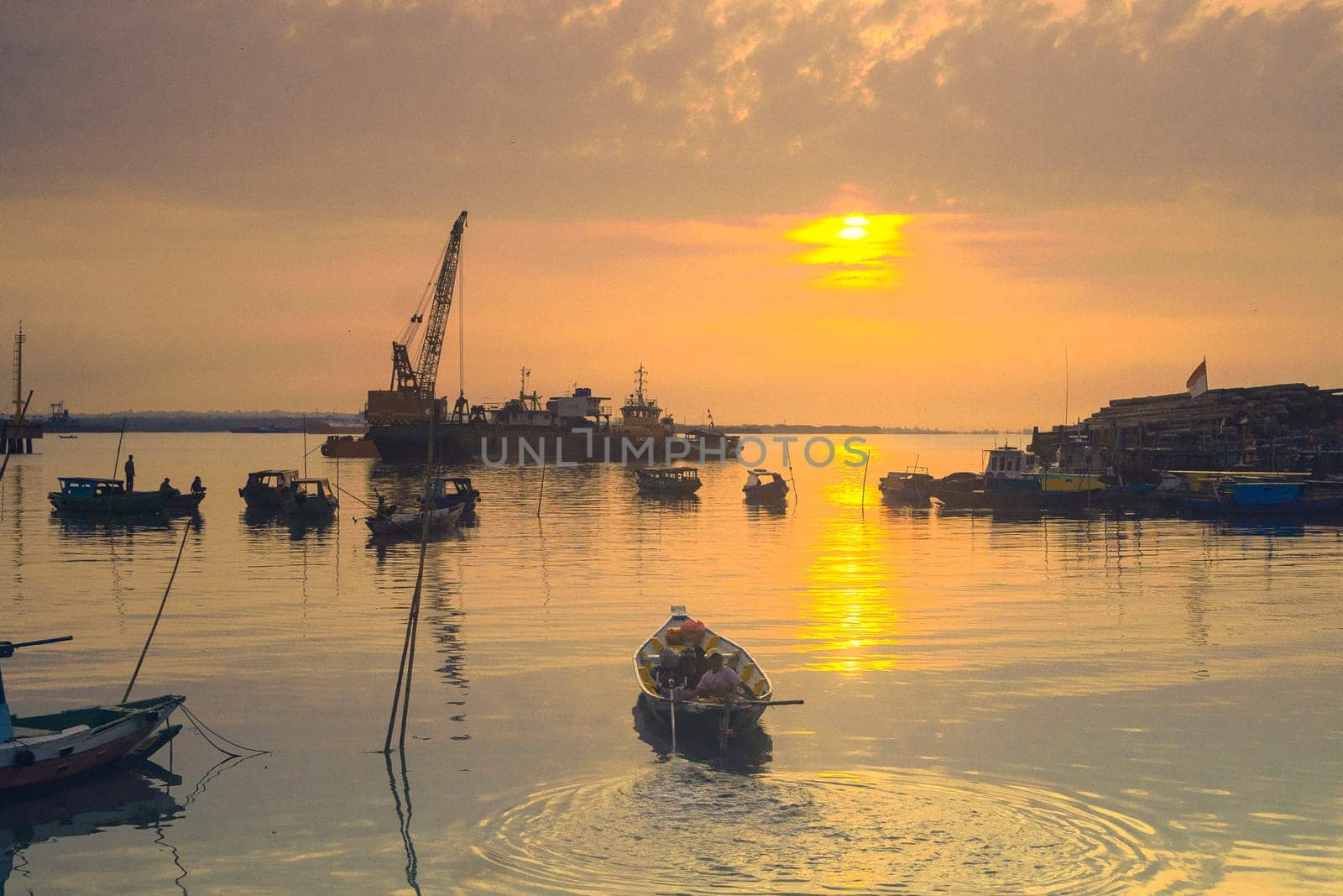 View of wooden pier on boat dock wharf in Gresik, East Java, Indonesia during sunrise