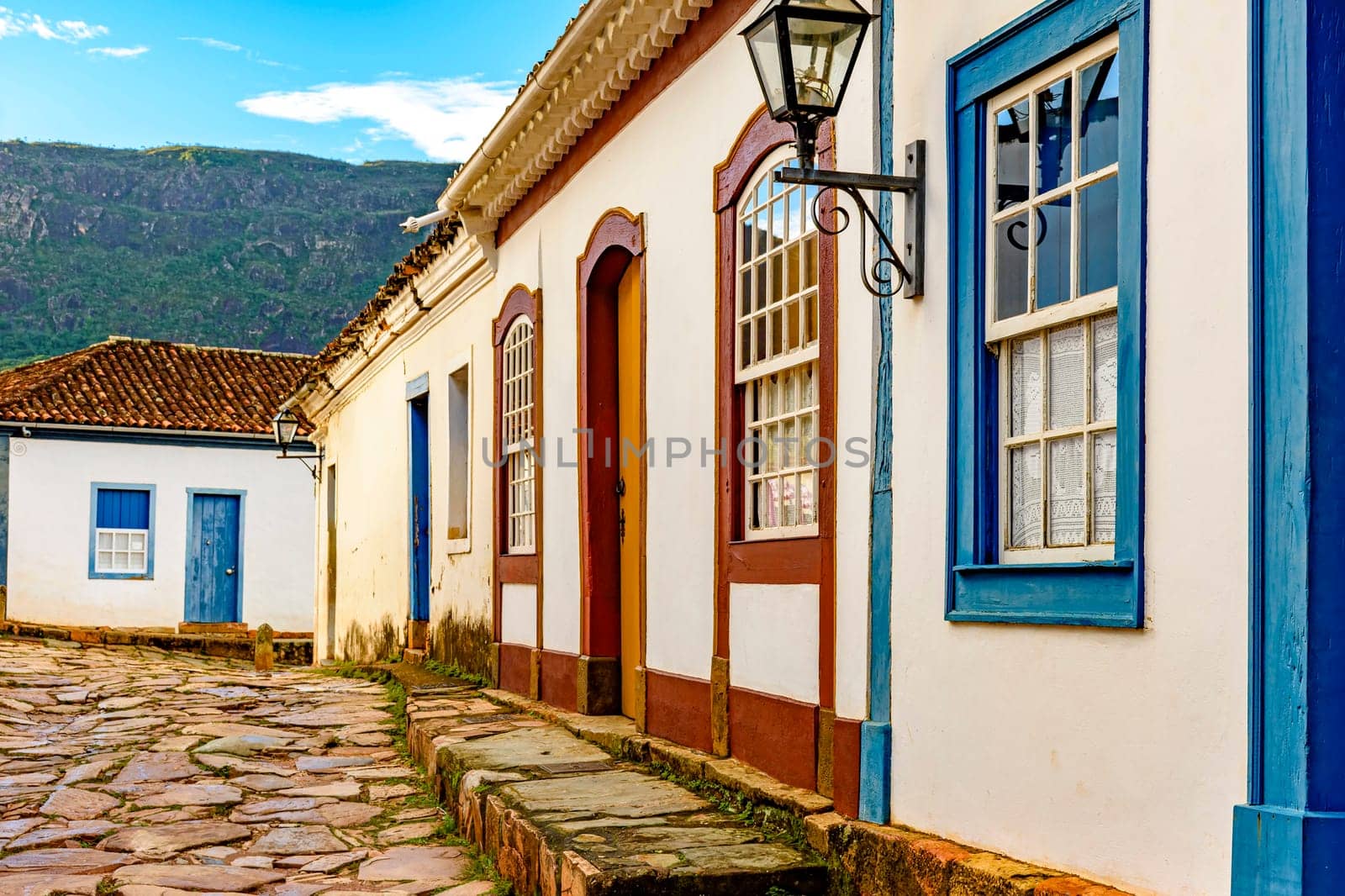 Cobblestone street and facade of old colonial style colorful houses in the historic city of Tiradentes in Minas Gerais, Brazil