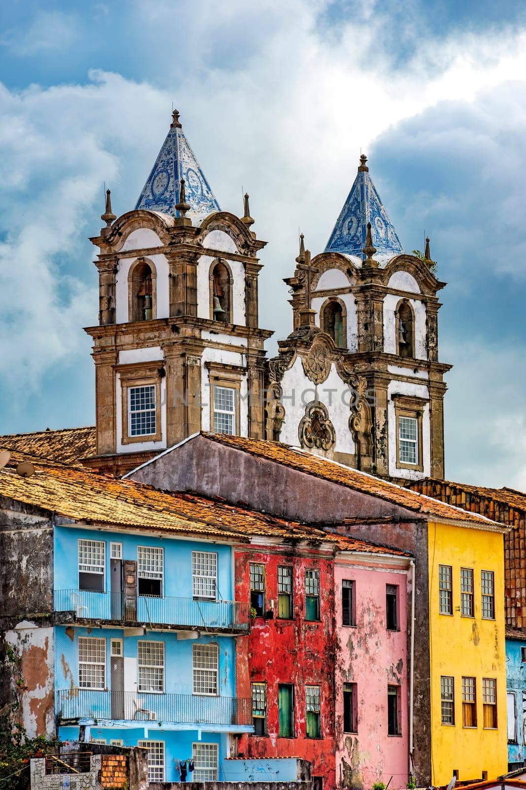 Historic baroque church towers rising between old colorful houses in the Pelourinho district in the city of Salvador, Bahia