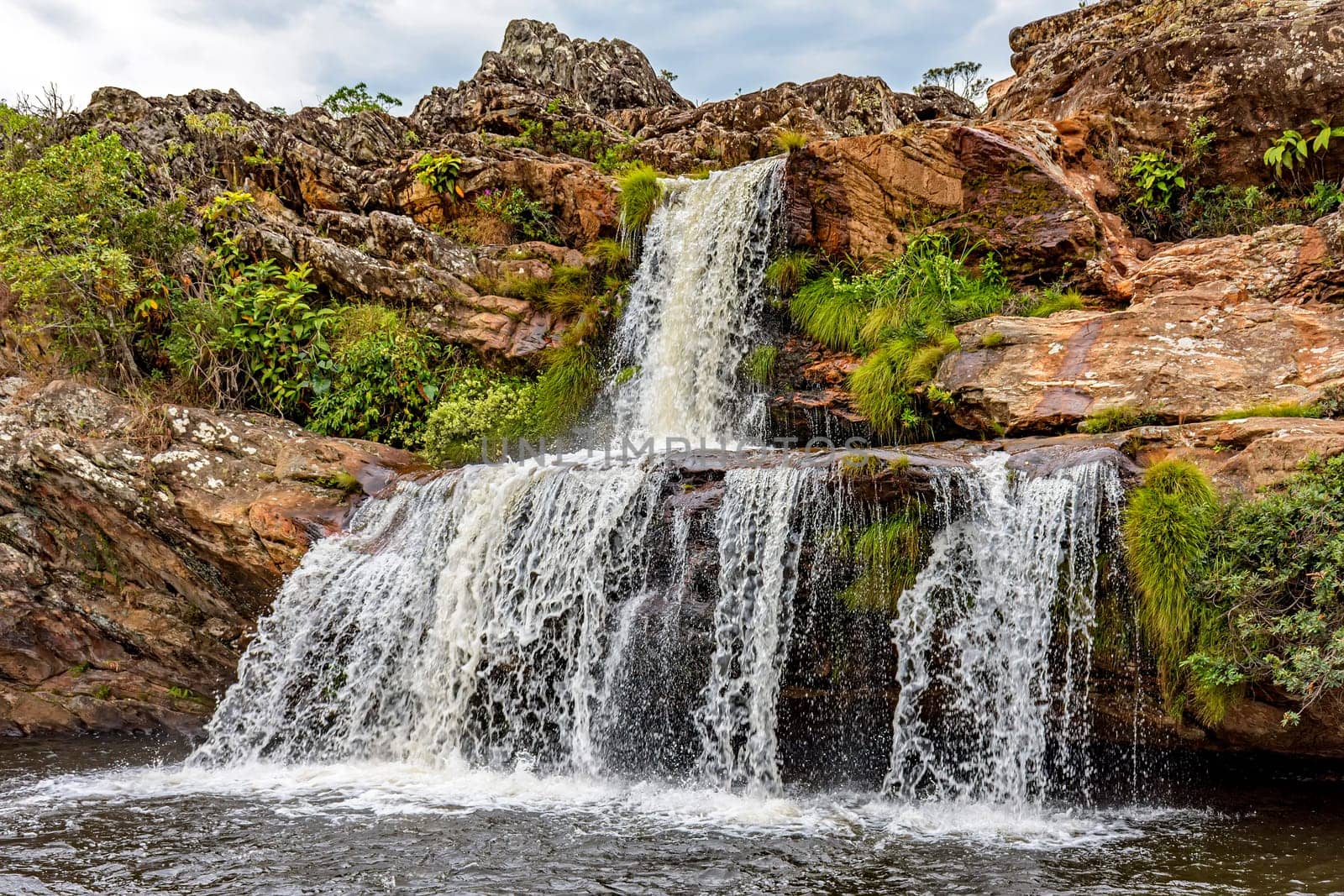 Waterfall between the rocks of Serra do Biribiri state park in Diamantina, Minas Gerais