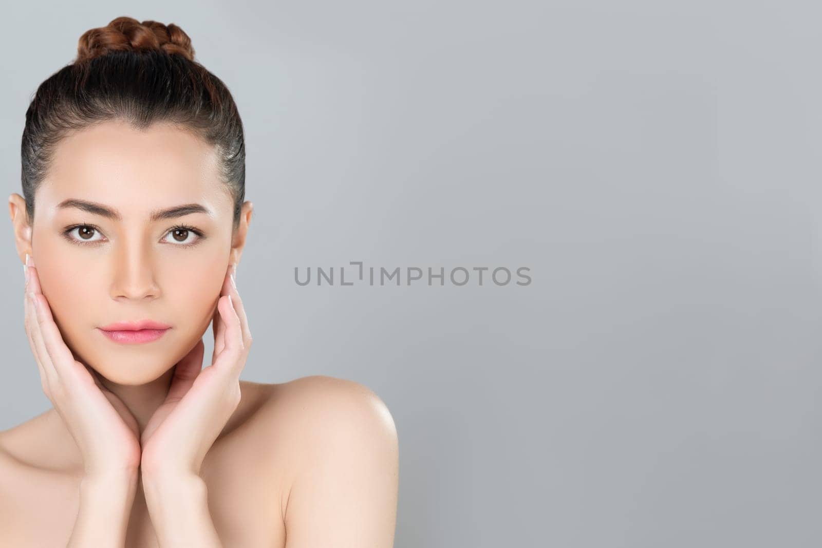 Glamorous woman portrait with perfect smooth pure clean skin with soft cosmetic makeup in isolated background. Beauty hand gesture with expressive facial expression for skincare product or spa ad.