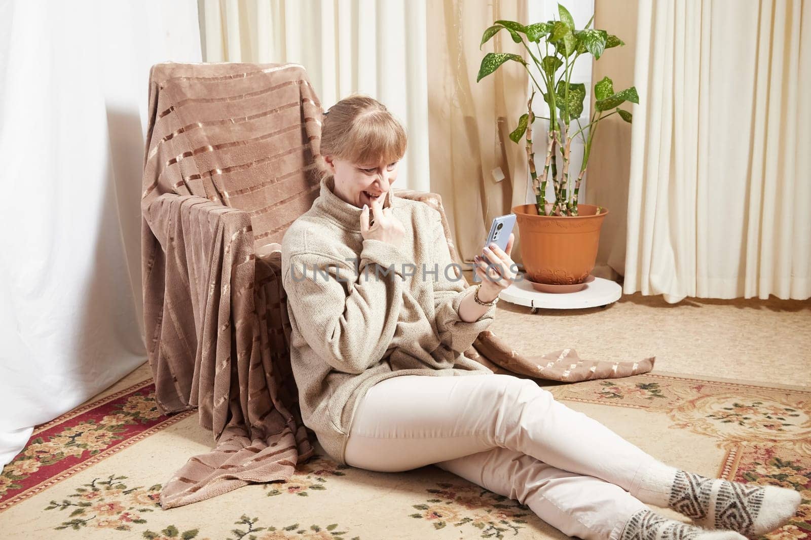 Adult woman with cell phone in room. Middle aged female customer holding smartphone using mobile app, texting message, search commerce offer on phone technology device at homes. Partial focus