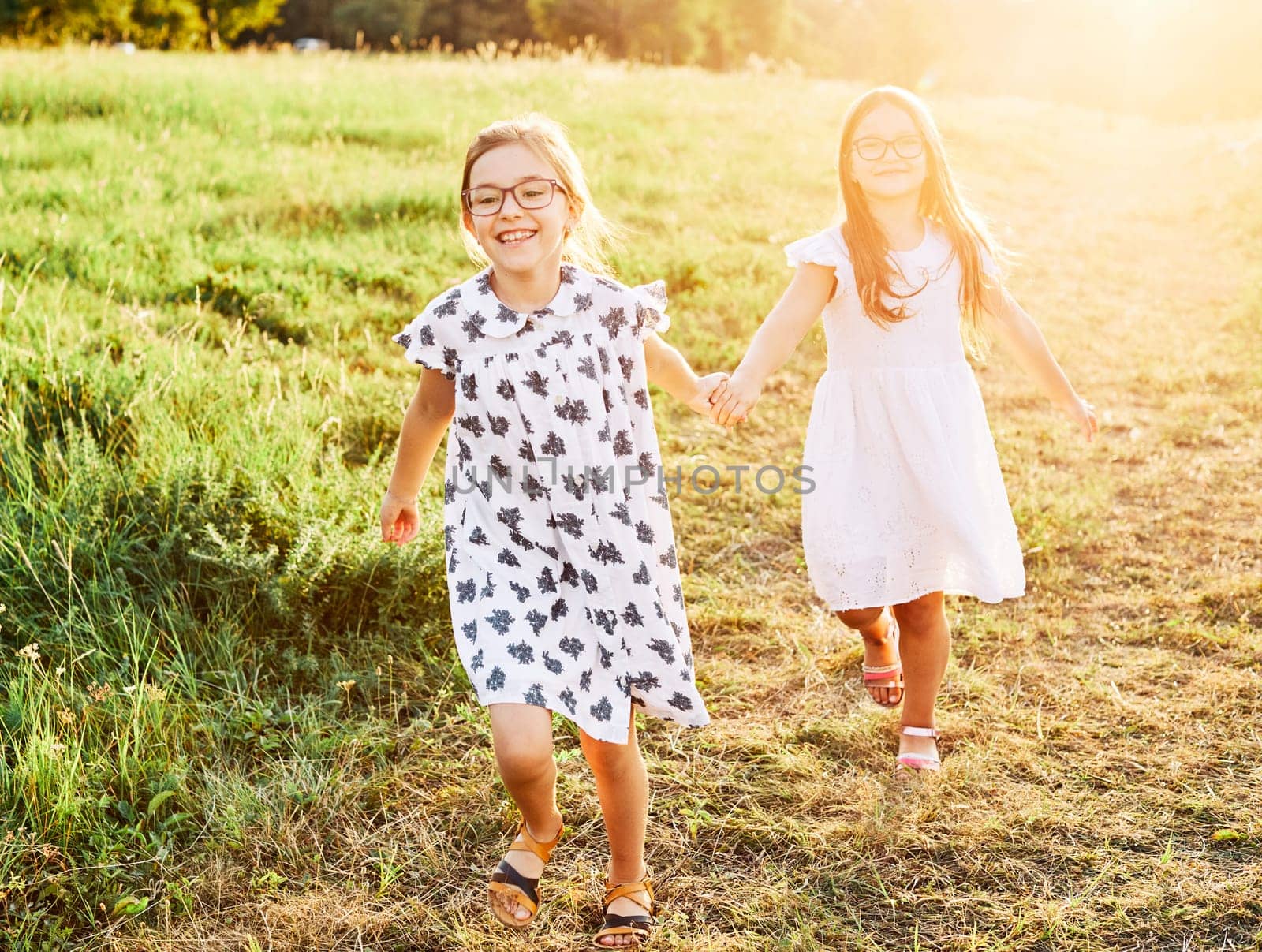 Happy little girls walking playing outdoors