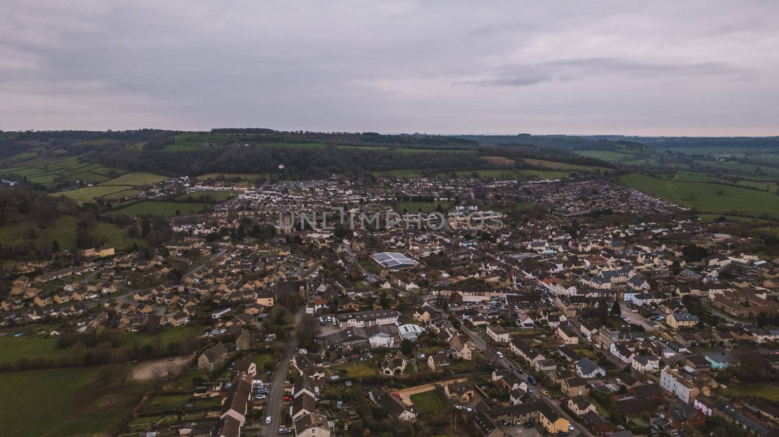 Aerial view of neighborhood surrounded by green landscape by fabioxavierphotography