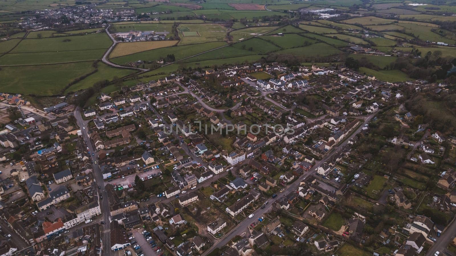 Aerial view of neighborhood surrounded by green landscape by fabioxavierphotography