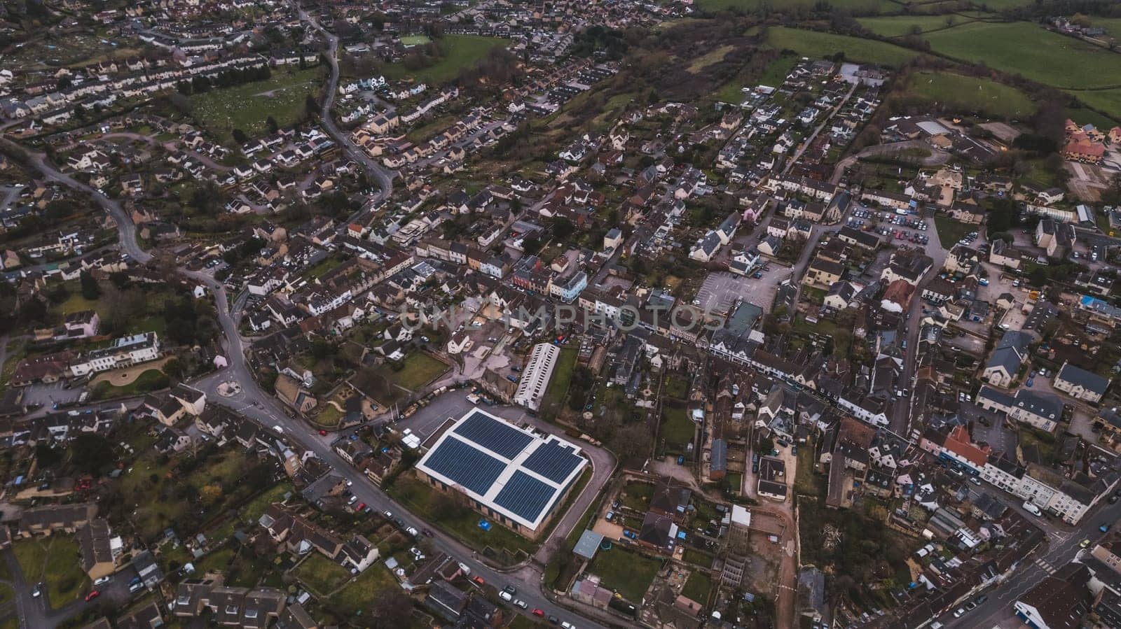 Aerial view of neighborhood surrounded by green landscape by fabioxavierphotography